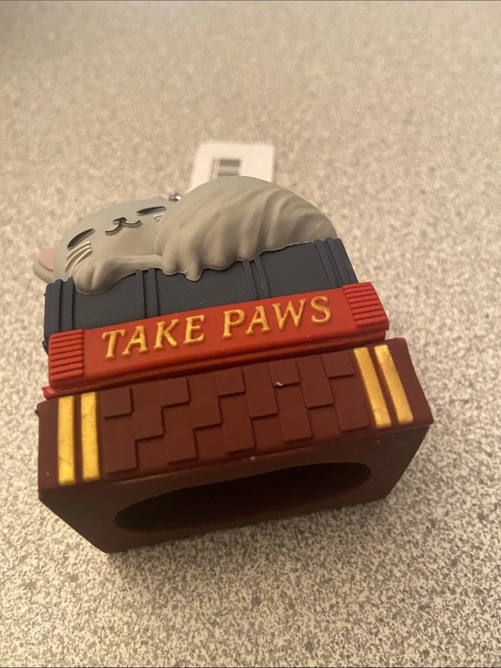 Cat on top of book hand sanitizer holder